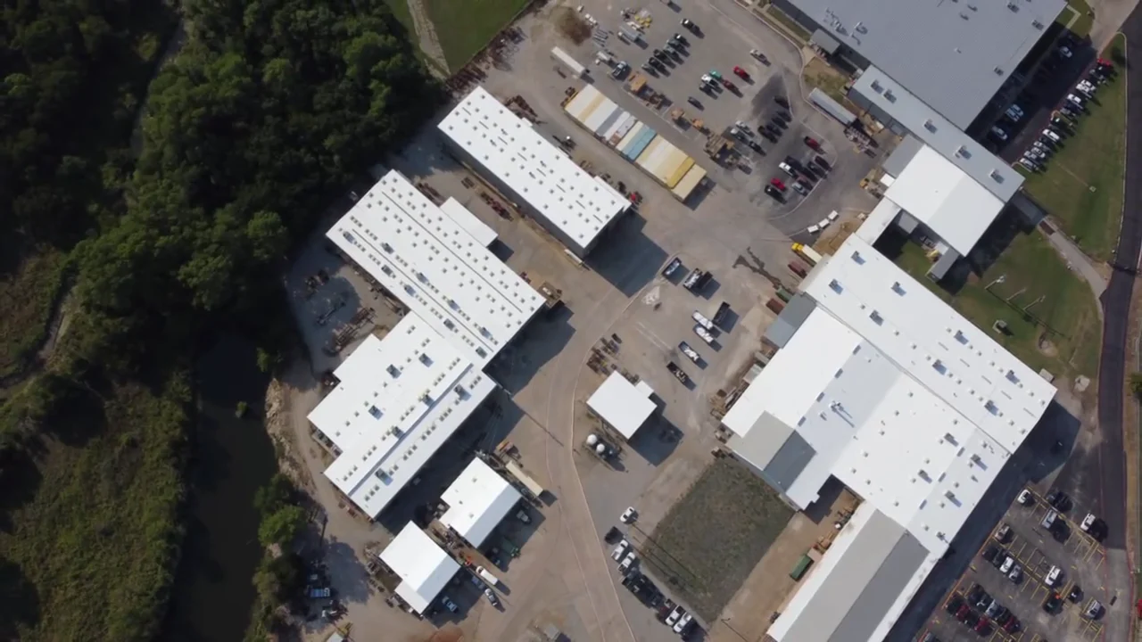 Aerial view of the completed white roof restoration across an industrial facility