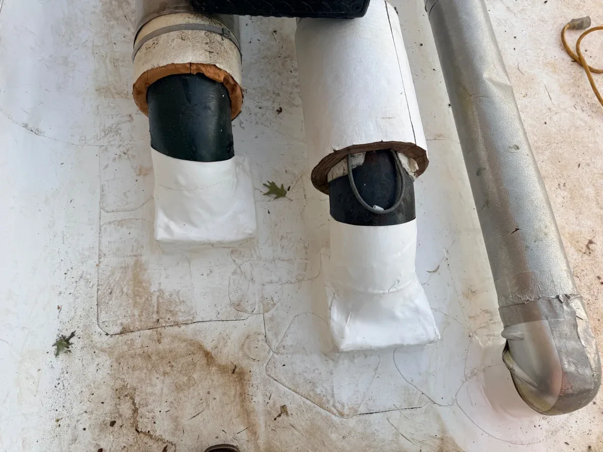 Roof penetrations and their flashings, the kind of details where air can leak between the roof and the deck