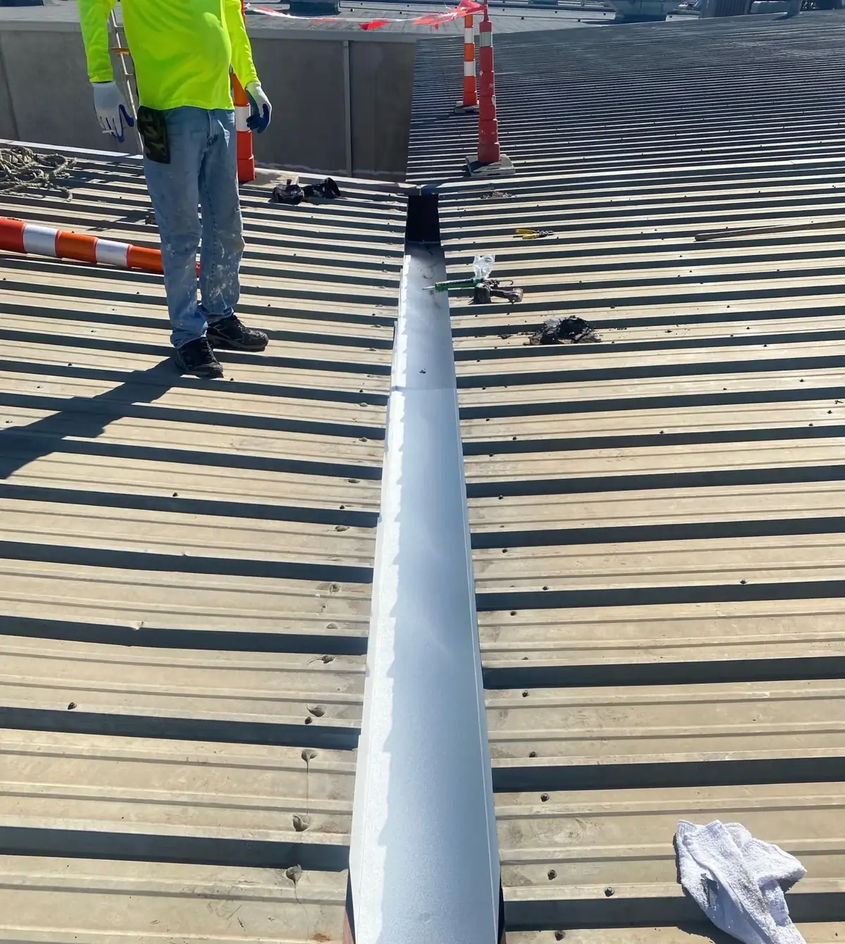 New metal lining fitted inside an internal gutter between two metal roof slopes