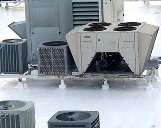 White restored roof surfaces around the medical facility’s rooftop equipment
