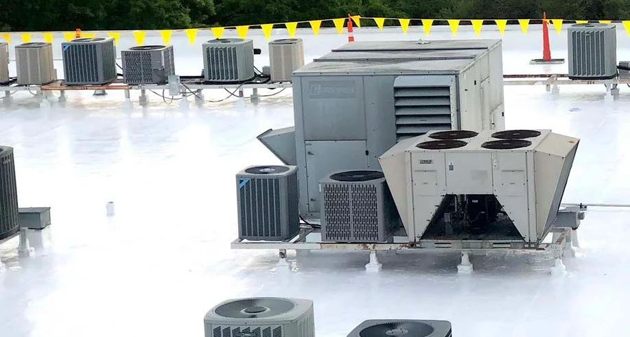 Completed white silicone roof restoration around rooftop equipment at the Jackson medical facility