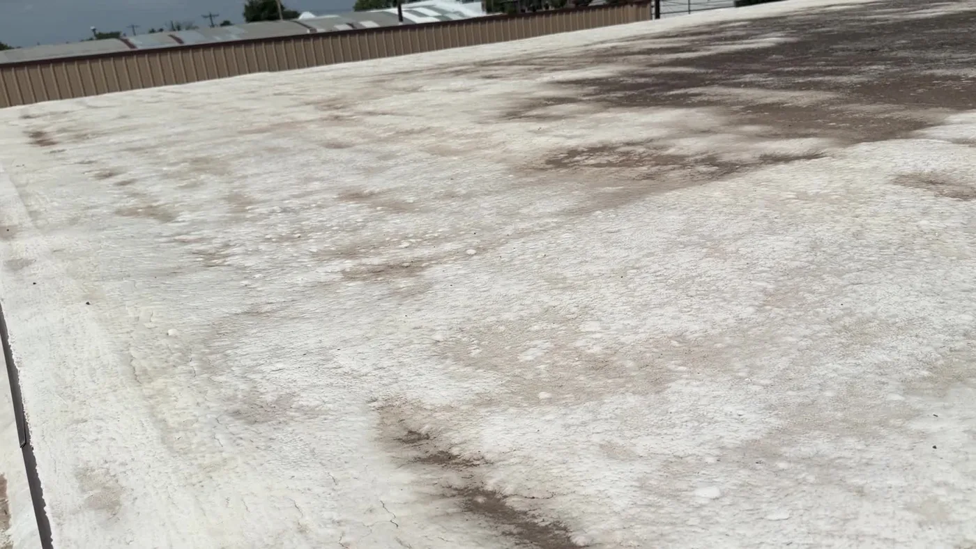 Stained and weathered low-slope roof surface in Ballinger, Texas