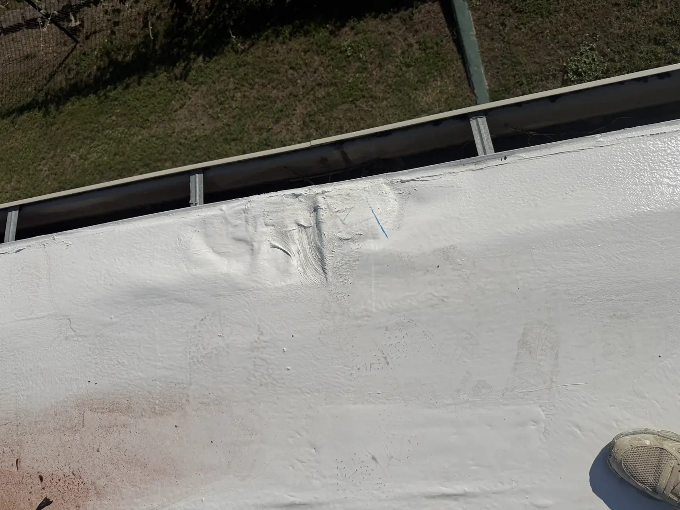 Finished white restored roof along the gutter edge
