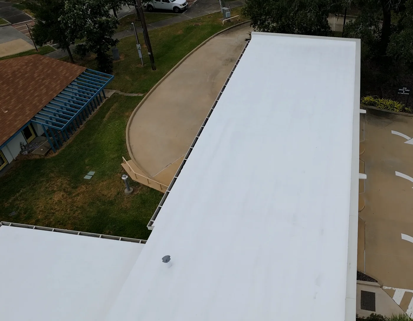 Finished white silicone roof edge seen from above