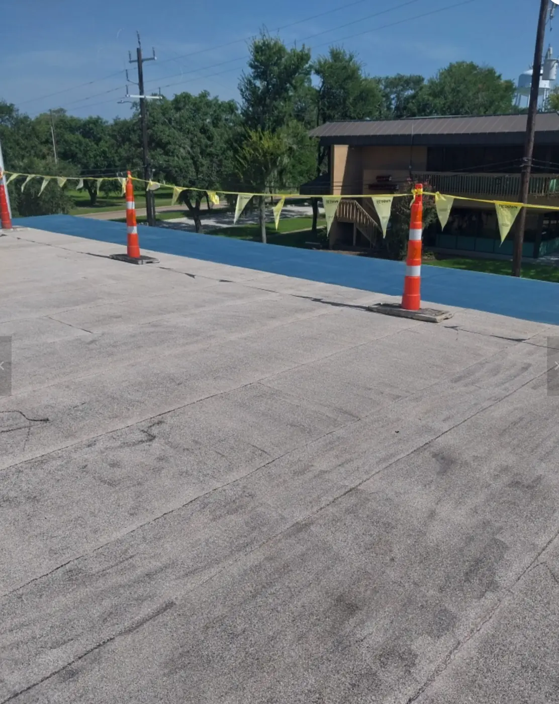 Blue base layer next to a section of bare roof partway through restoration