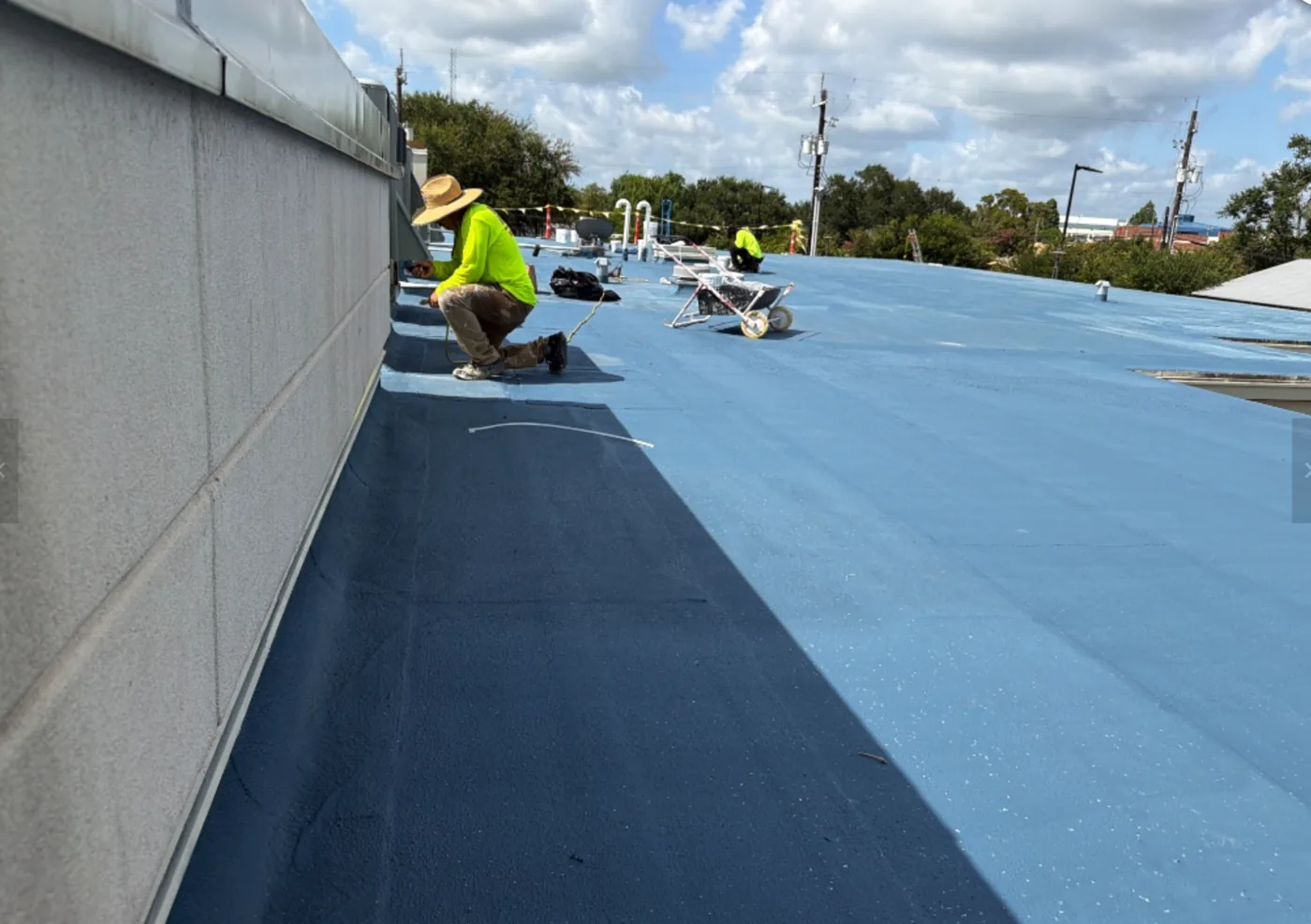 Ramtech crew working along a parapet wall during restoration