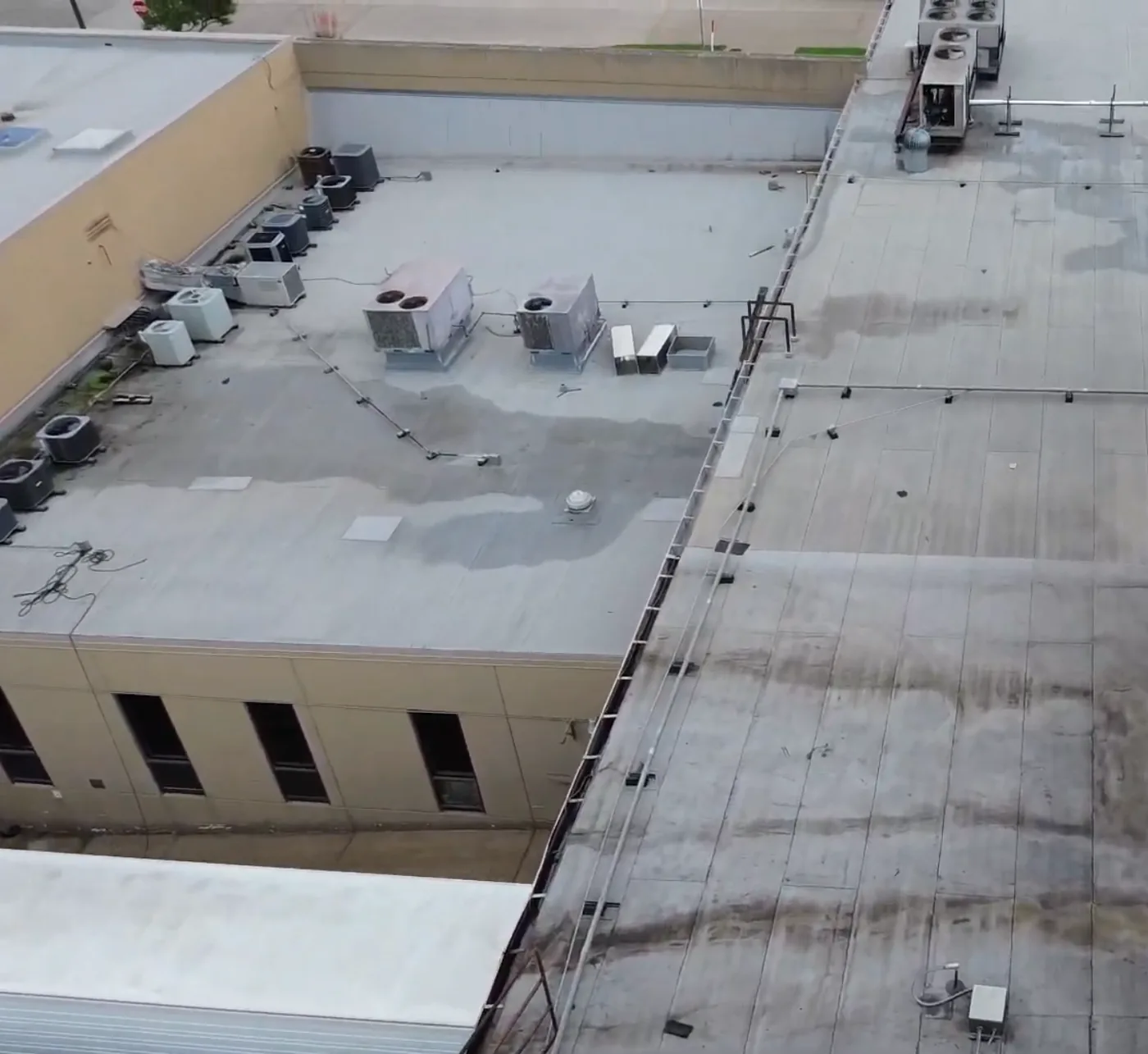 Drone view of the aged, stained roof sections at a food processing facility in Mansfield before restoration