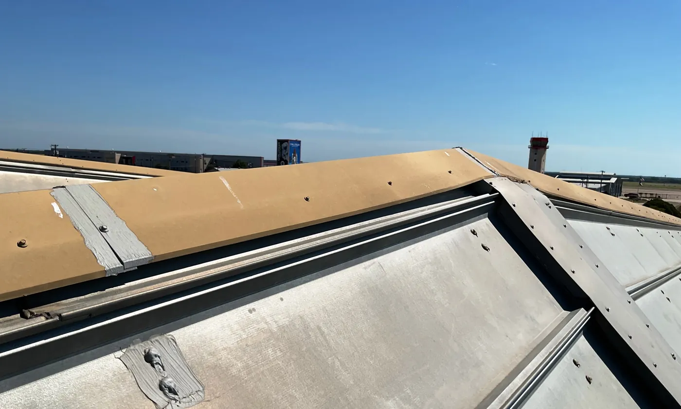 Open flashing joint at the edge of a long skylight on a metal roof