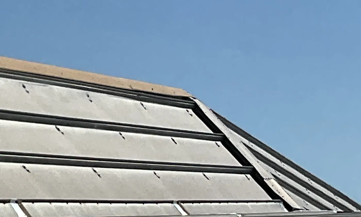 Row of skylight panels along a sloped metal roof