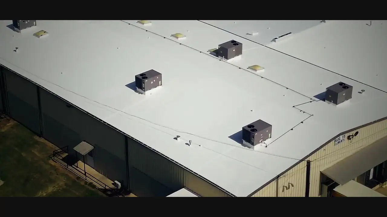 Ramtech crew member on a white commercial roof